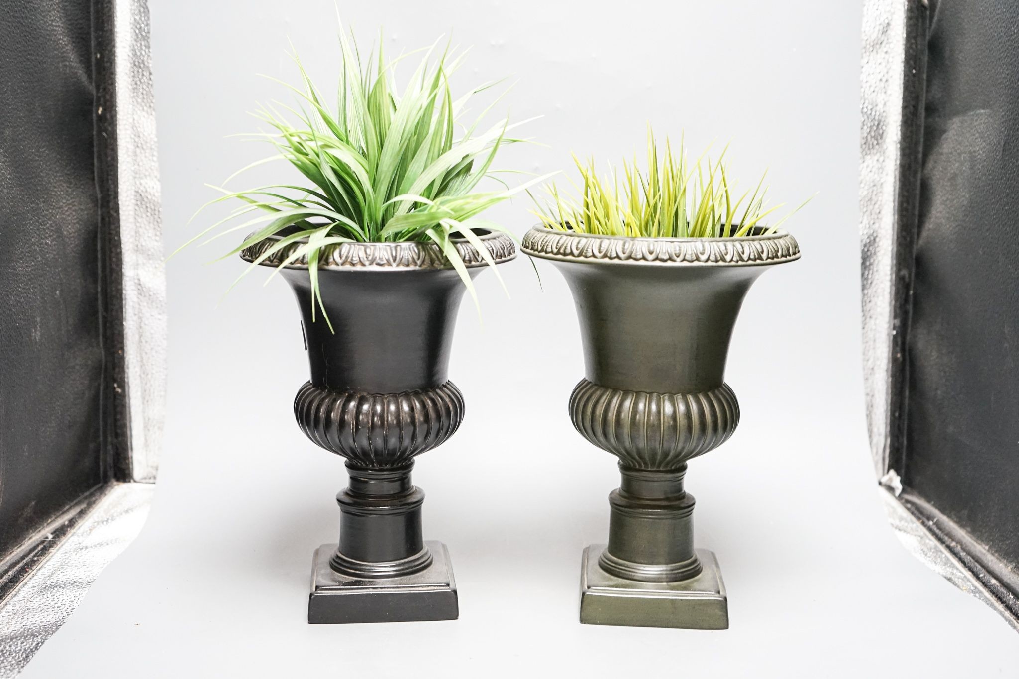 A pair of reproduction plaster urns 28cm